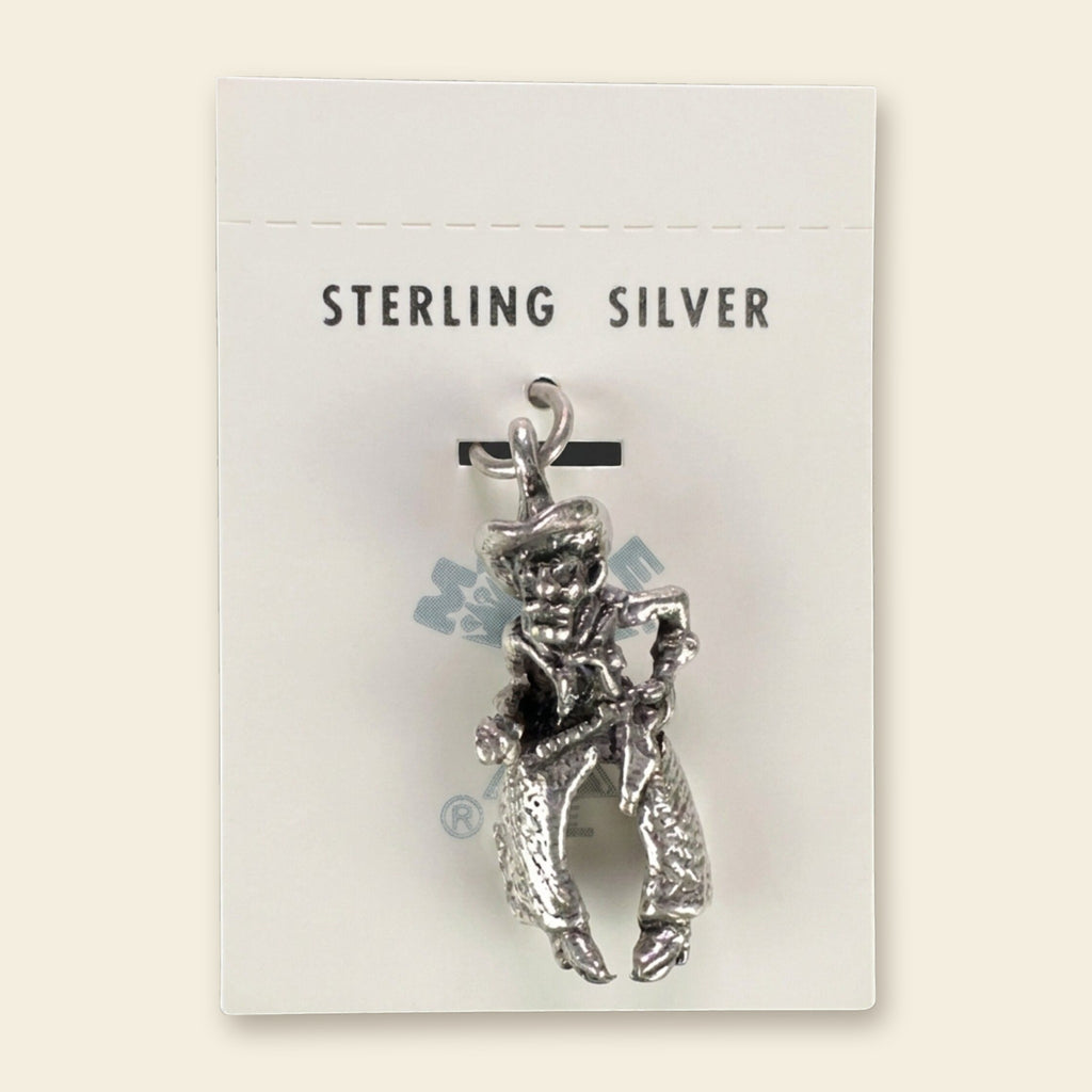 Vintage Maisel's Sterling Silver Cowboy Charm, New Old Stock, shown on an ivory background