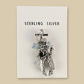 Vintage Maisel's Sterling Silver Cowboy Charm, New Old Stock, shown on a sand background