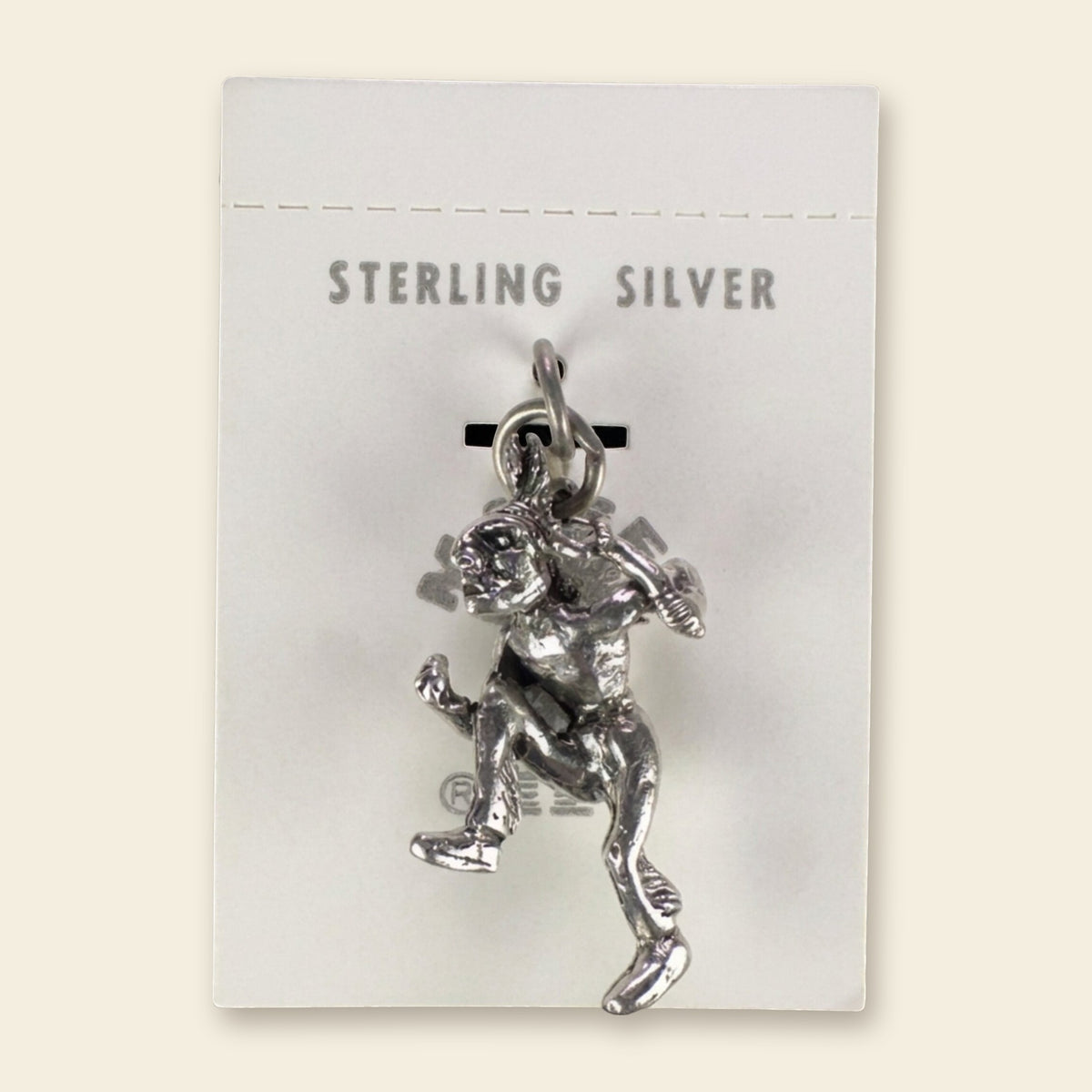 Vintage Maisel's Sterling Silver Dancer Charm, New Old Stock, shown on an ivory background