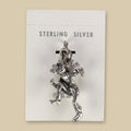 Vintage Maisel's Sterling Silver Dancer Charm, New Old Stock, shown on a sand background
