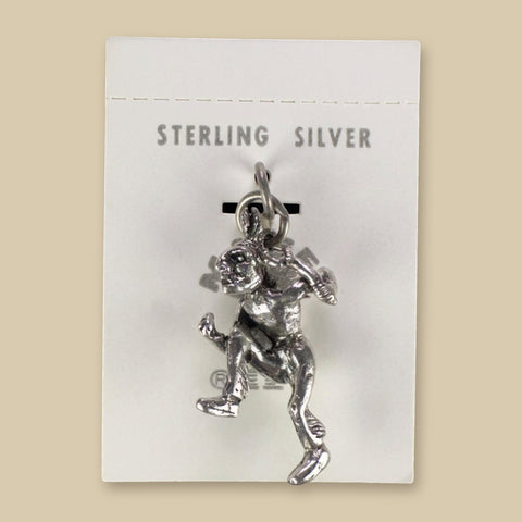 Vintage Maisel's Sterling Silver Dancer Charm, New Old Stock, shown on a sand background