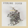 Vintage Maisel's Sterling Silver Jackrabbit Charm, New Old Stock, shown on a desert plaster background