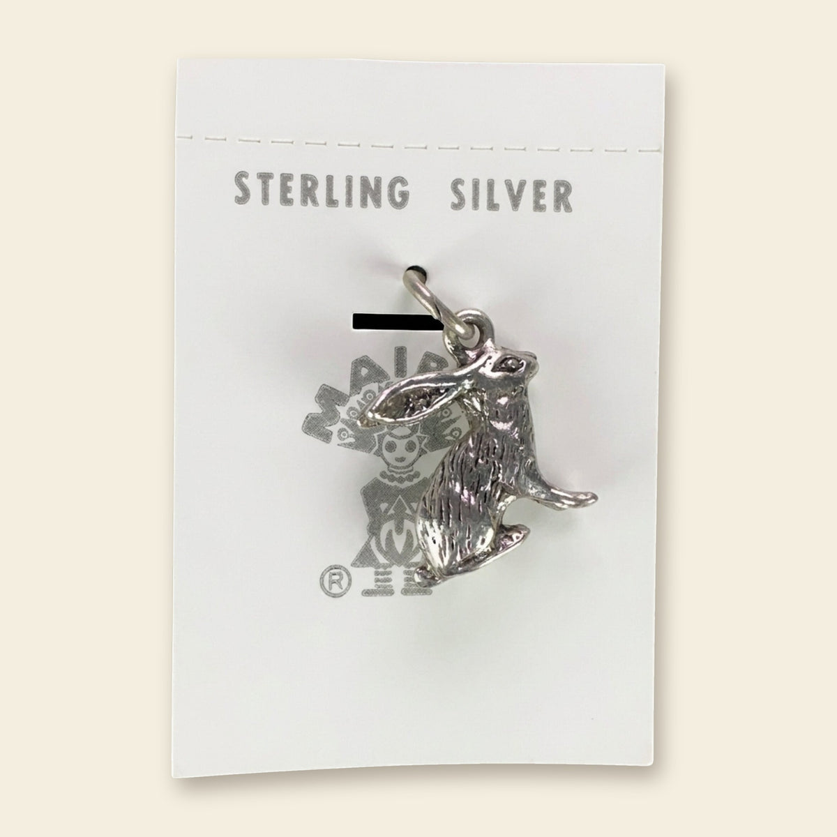Vintage Maisel's Sterling Silver Jackrabbit Charm, New Old Stock, shown on an ivory background