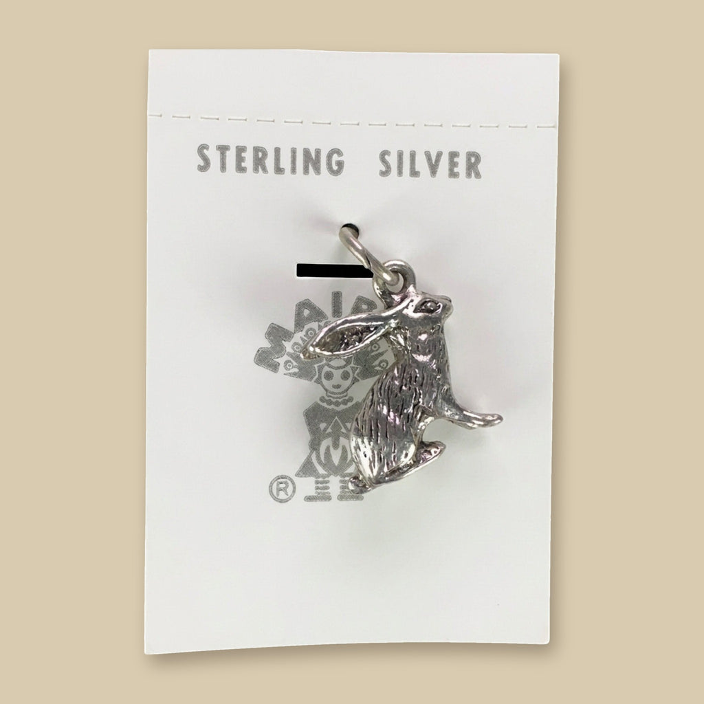 Vintage Maisel's Sterling Silver Jackrabbit Charm, New Old Stock, shown on a sand background