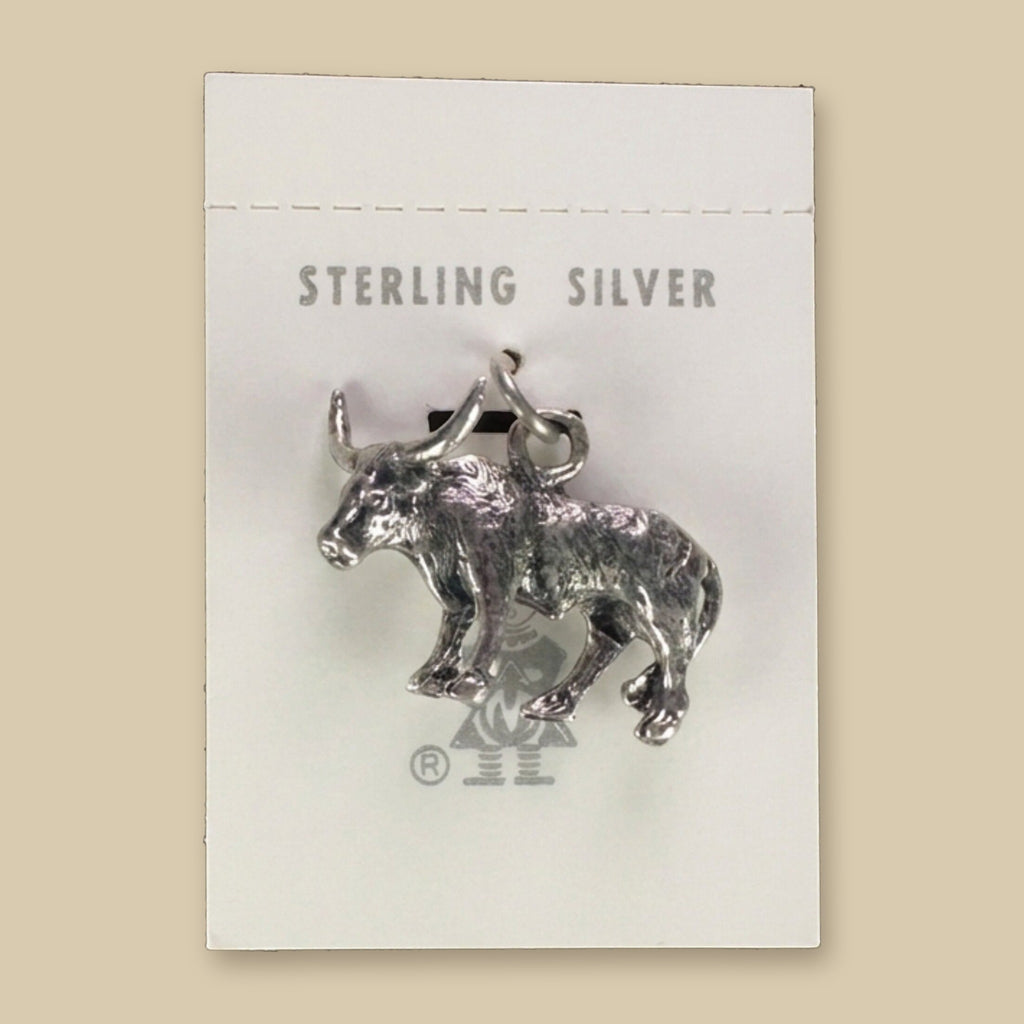 Vintage Maisel's Sterling Silver Longhorn Charm, New Old Stock, shown on a sand background