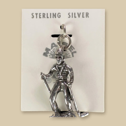 Vintage Maisel's Sterling Silver Skier Charm, New Old Stock, shown on a sand background