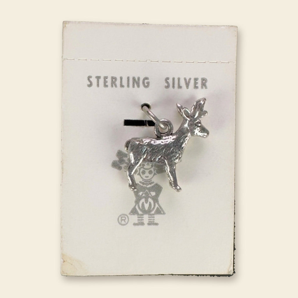 Vintage Maisel's Sterling Silver Standing Elk Charm, New Old Stock, shown on an ivory background