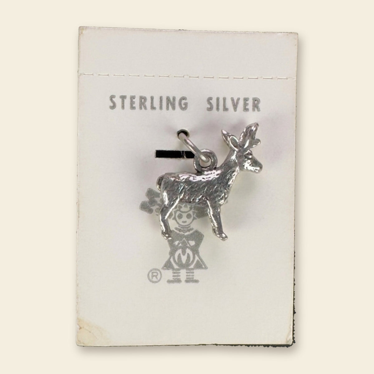 Vintage Maisel's Sterling Silver Standing Elk Charm, New Old Stock, shown on an ivory background