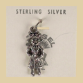 Vintage Maisel's Sterling Silver Standing Figure Charm, New Old Stock, shown on a desert plaster background