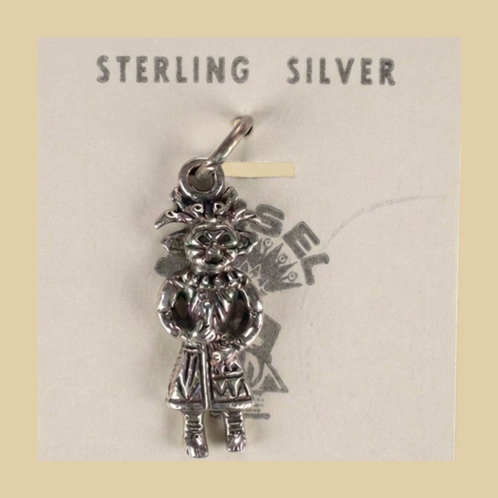 Vintage Maisel's Sterling Silver Standing Figure Charm, New Old Stock, shown on a desert plaster background