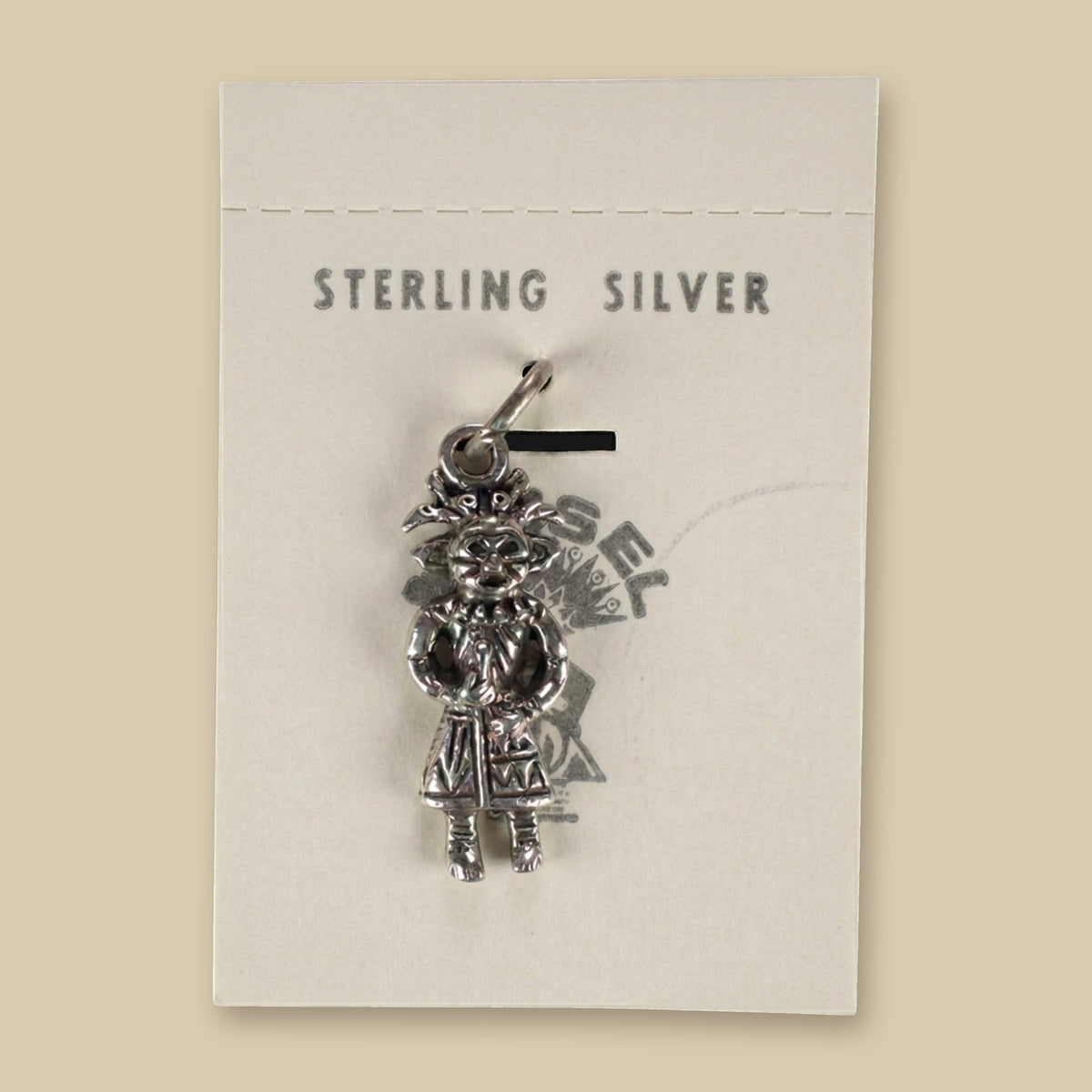 Vintage Maisel's Sterling Silver Standing Figure Charm, New Old Stock, shown on a sand background