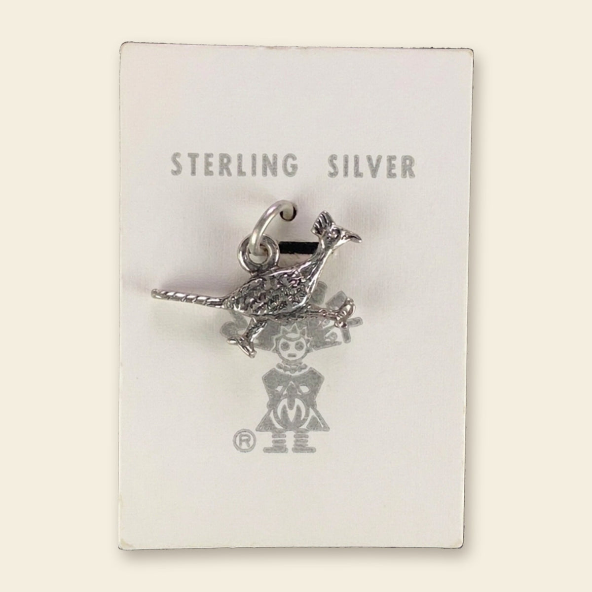 Vintage Maisel's Sterling Silver Textured Roadrunner Charm, New Old Stock, shown on an ivory background