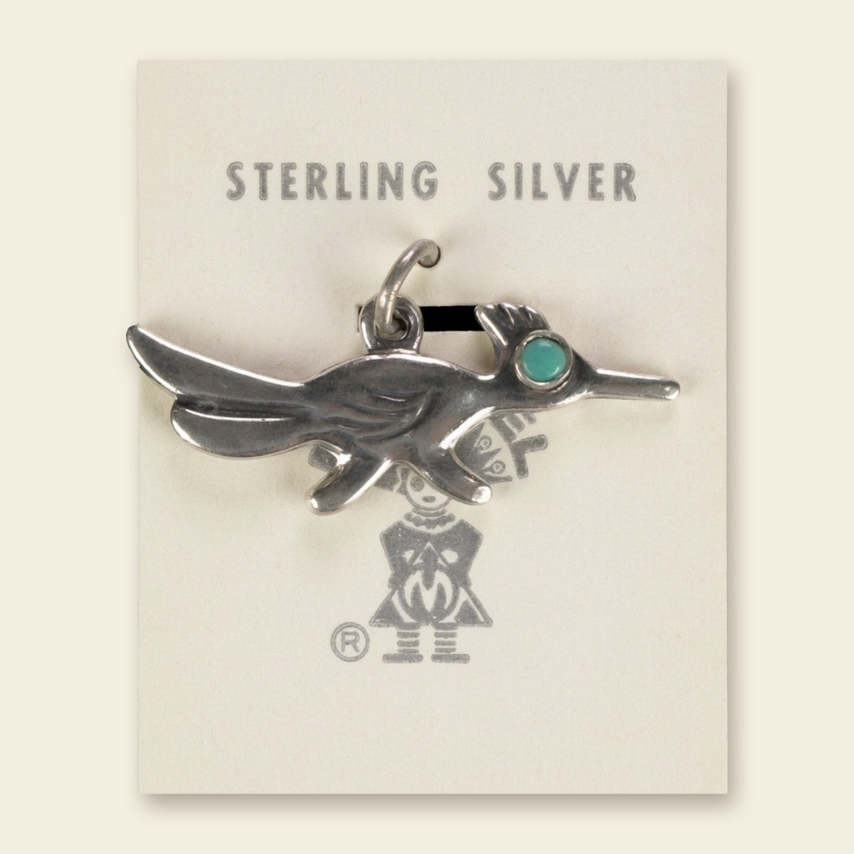 Vintage Maisel's Sterling Silver Turquoise Eye Roadrunner Charm, New Old Stock, shown on an ivory background