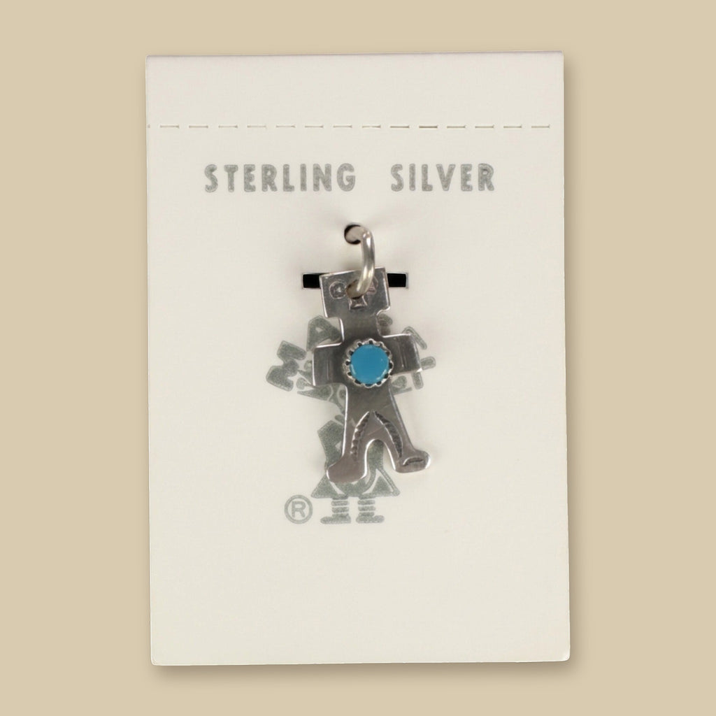 Vintage Maisel's Sterling Silver Turquoise Figure Charm, New Old Stock, shown on a sand background