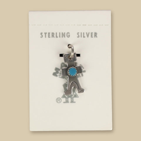 Vintage Maisel's Sterling Silver Turquoise Figure Charm, New Old Stock, shown on a sand background