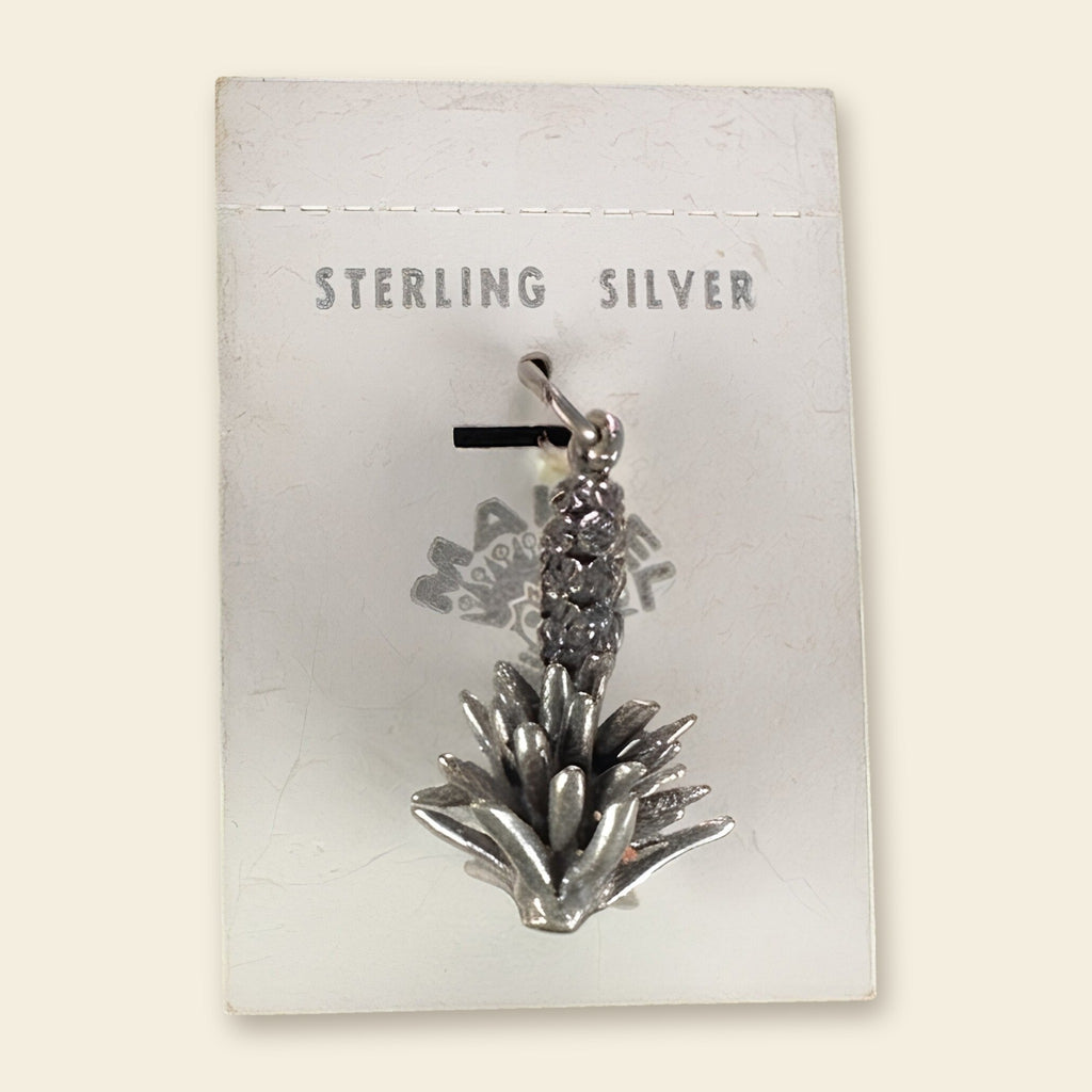 Vintage Maisel's Sterling Silver Yucca Charm, New Old Stock, shown on an ivory background