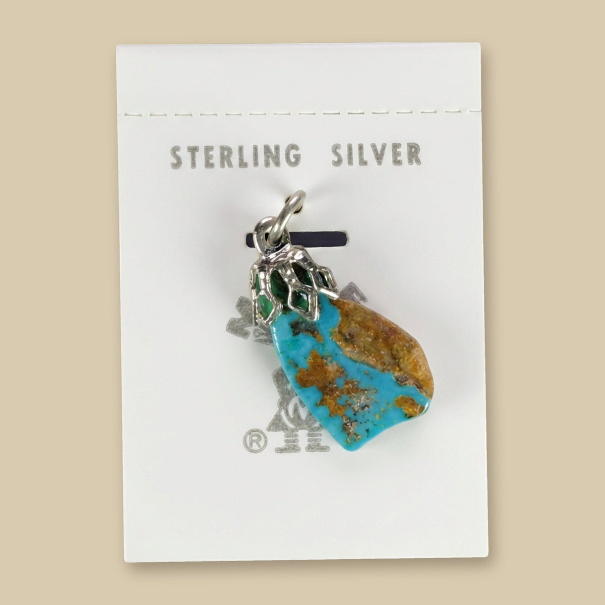 Vintage Maisel's Turquoise Nugget Sterling Silver Pendant, New Old Stock, shown on a sand background