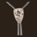 White Buffalo Bolo Tie in Navajo Sterling Silver, by P. Yazzie, shown on an espresso background