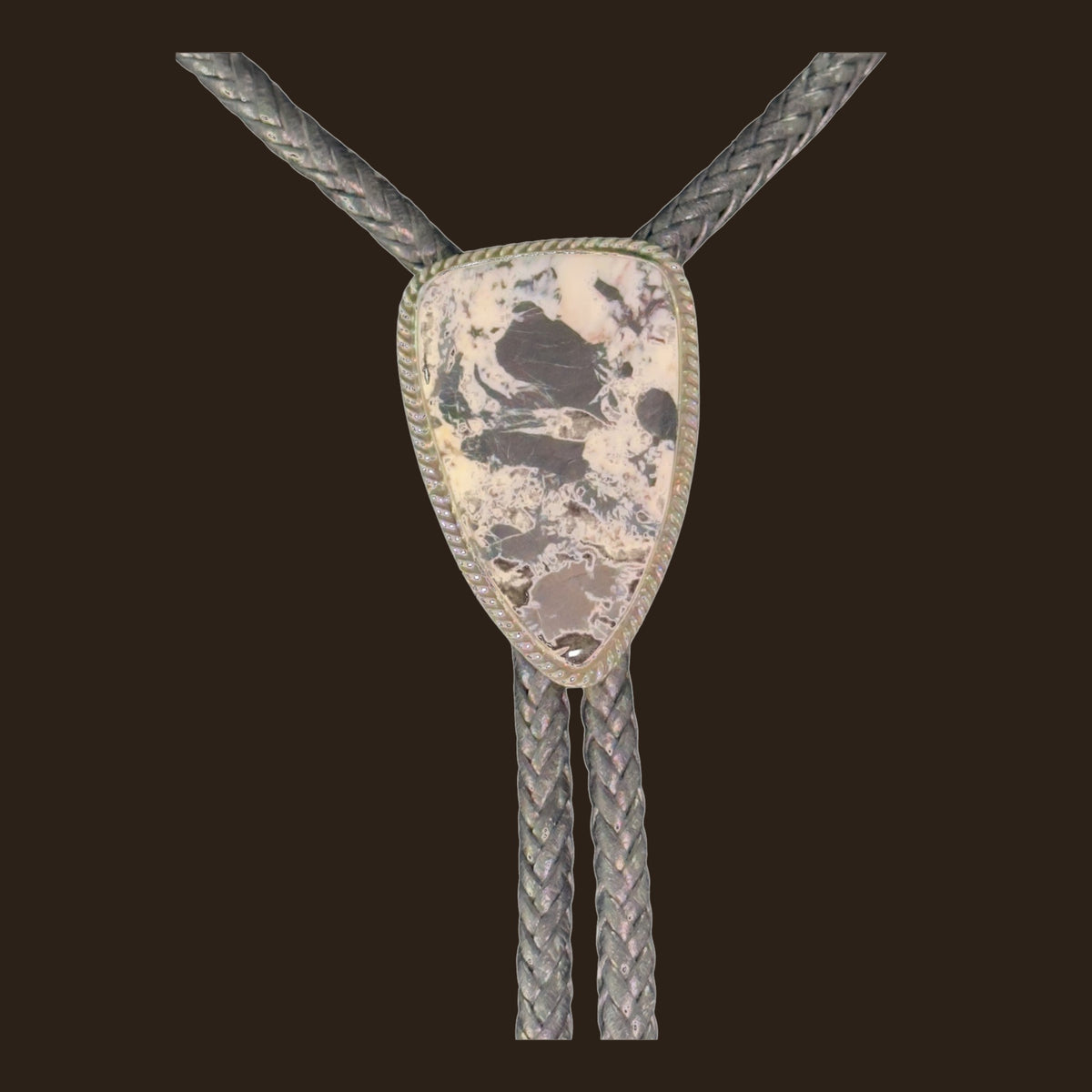 White Buffalo Bolo Tie in Navajo Sterling Silver, by P. Yazzie, shown on an espresso background
