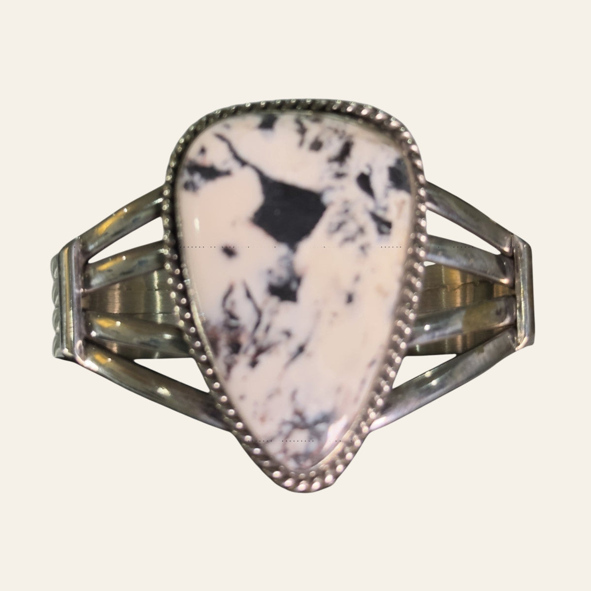 White Buffalo Cuff Bracelet in Navajo Sterling Silver, by P. Yazzie, shown on a cream background