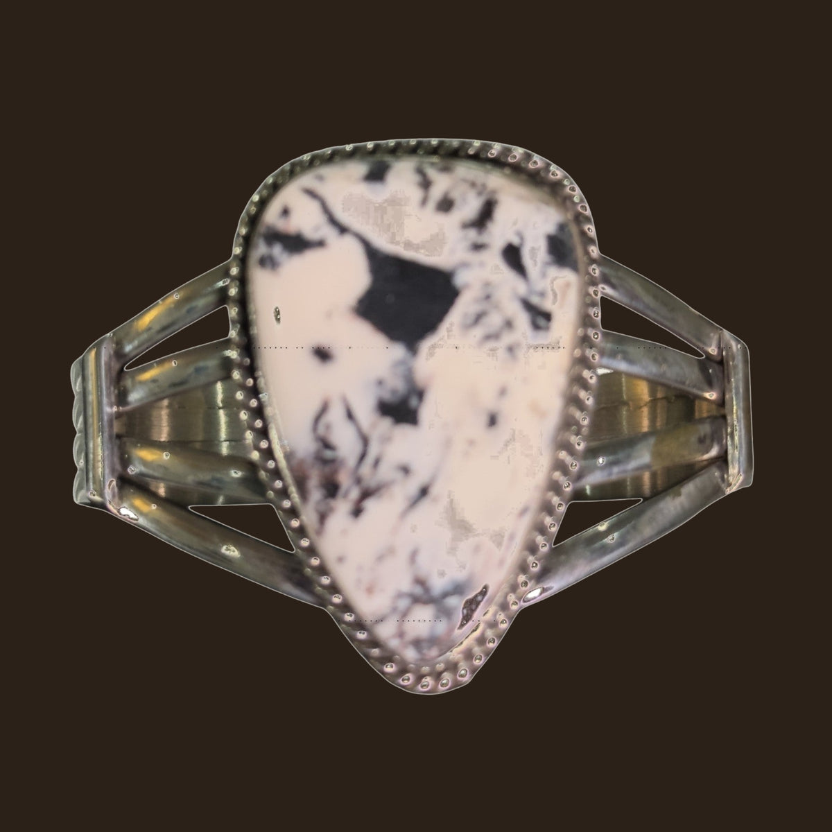 White Buffalo Cuff Bracelet in Navajo Sterling Silver, by P. Yazzie, shown on an espresso background