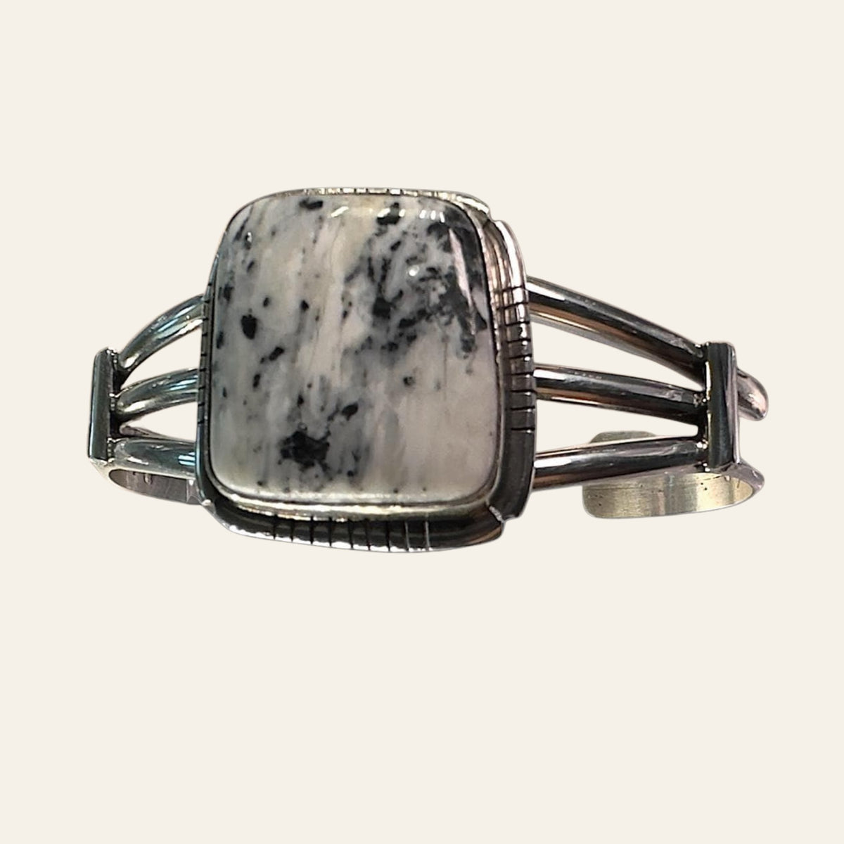 White Buffalo Cuff Bracelet in Navajo Sterling Silver, shown on a cream background