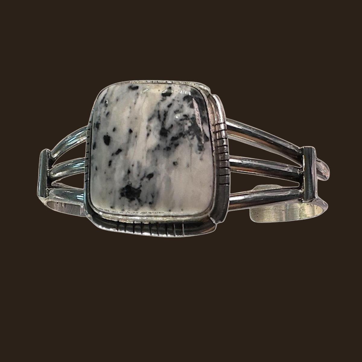 White Buffalo Cuff Bracelet in Navajo Sterling Silver, shown on an espresso background