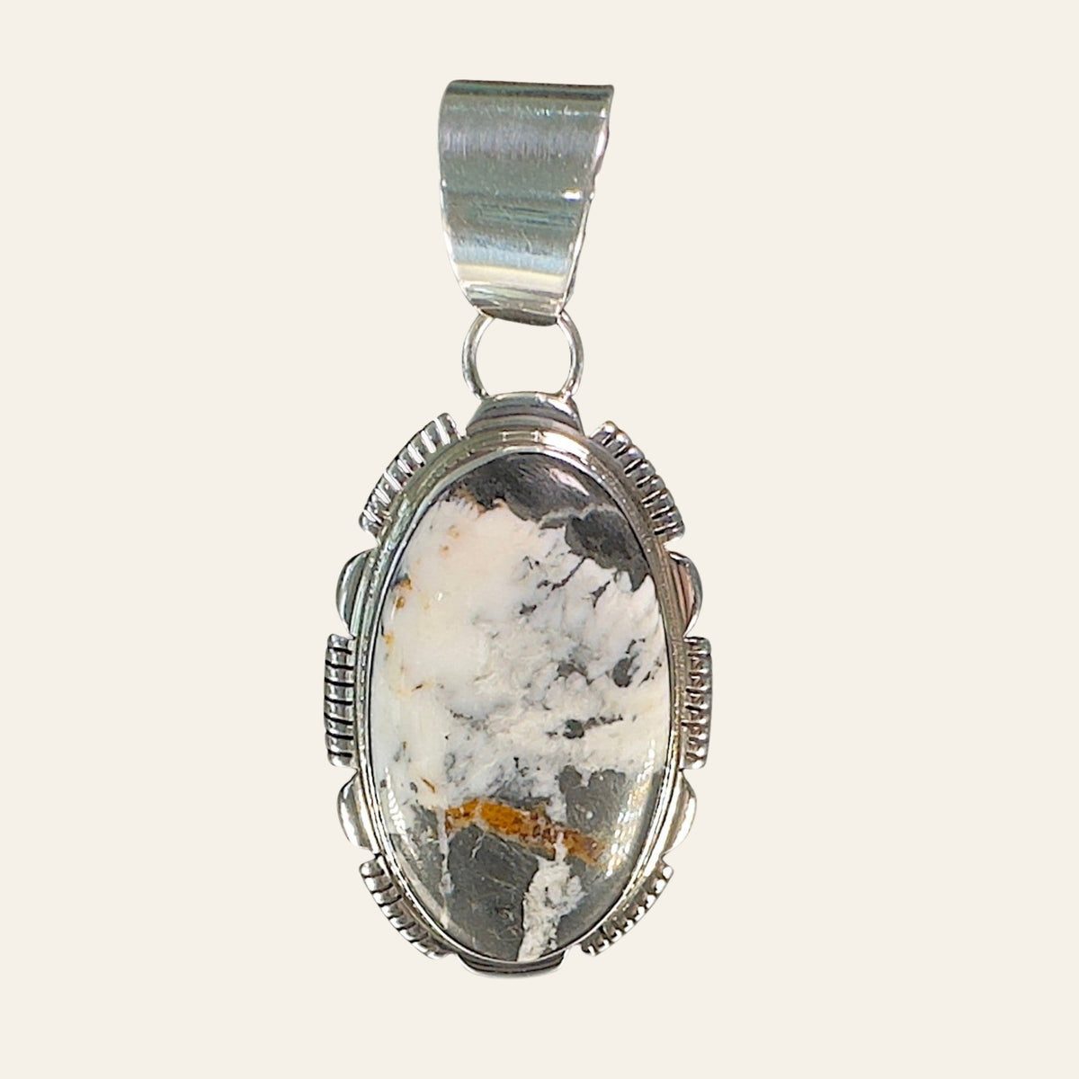 White Buffalo Pendant Necklace in Navajo Sterling Silver, by Leslie Yazzie, shown on a cream background