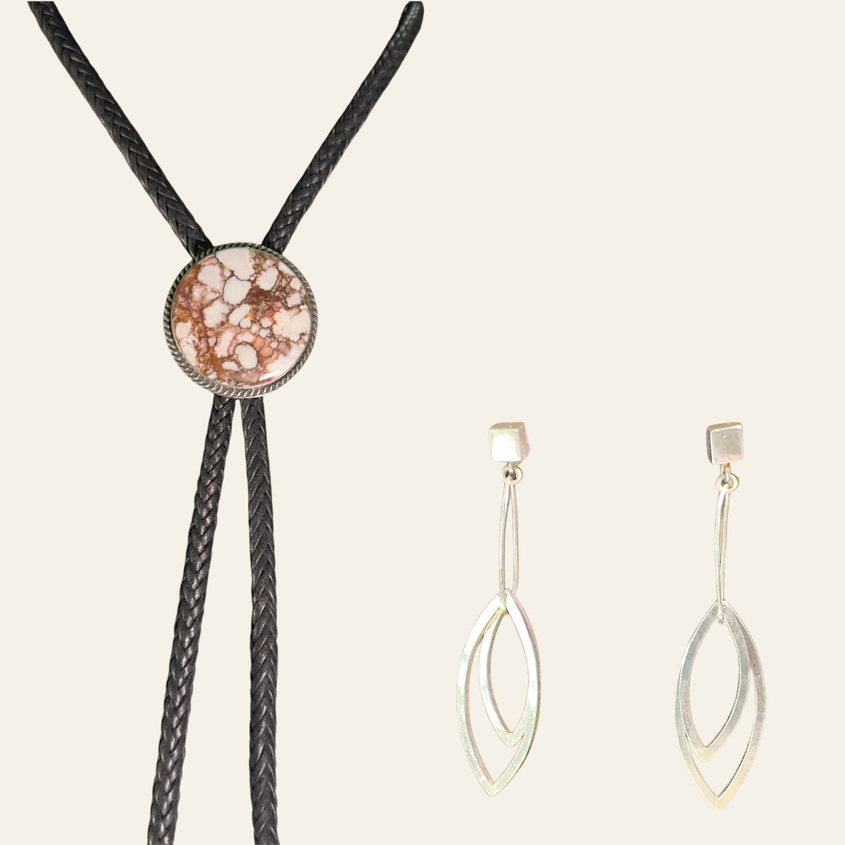 Wild Horse Bolo Tie and Leaf Earrings Set in Sterling Silver, shown on a cream background