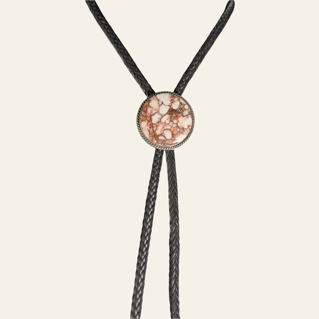 Wild Horse Bolo Tie in Navajo Sterling Silver, by P. Yazzie, shown on a cream background