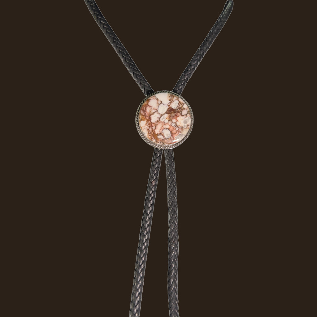 Wild Horse Bolo Tie in Navajo Sterling Silver, by P. Yazzie, shown on an espresso background