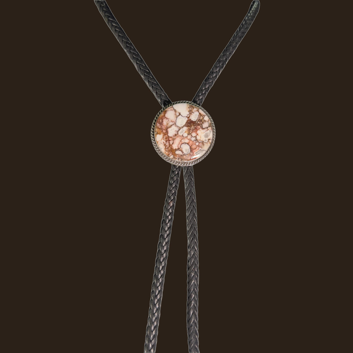 Wild Horse Bolo Tie in Navajo Sterling Silver, by P. Yazzie, shown on an espresso background