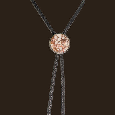 Wild Horse Bolo Tie in Navajo Sterling Silver, by P. Yazzie, shown on an espresso background