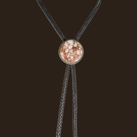 Wild Horse Bolo Tie in Navajo Sterling Silver, by P. Yazzie, shown on an espresso background