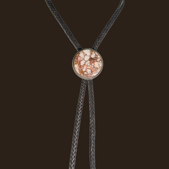 Wild Horse Bolo Tie in Navajo Sterling Silver, by P. Yazzie, shown on an espresso background