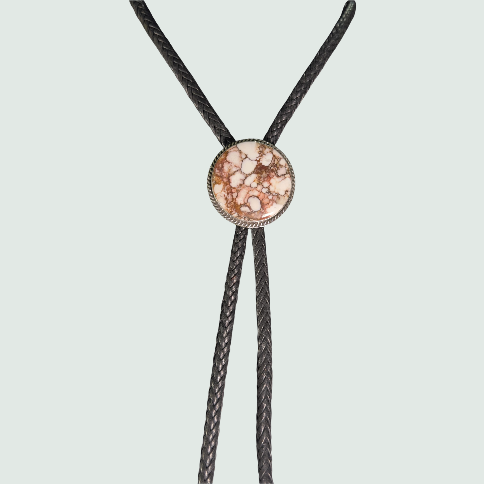Wild Horse Bolo Tie in Navajo Sterling Silver, by P. Yazzie, shown on a sage mist background