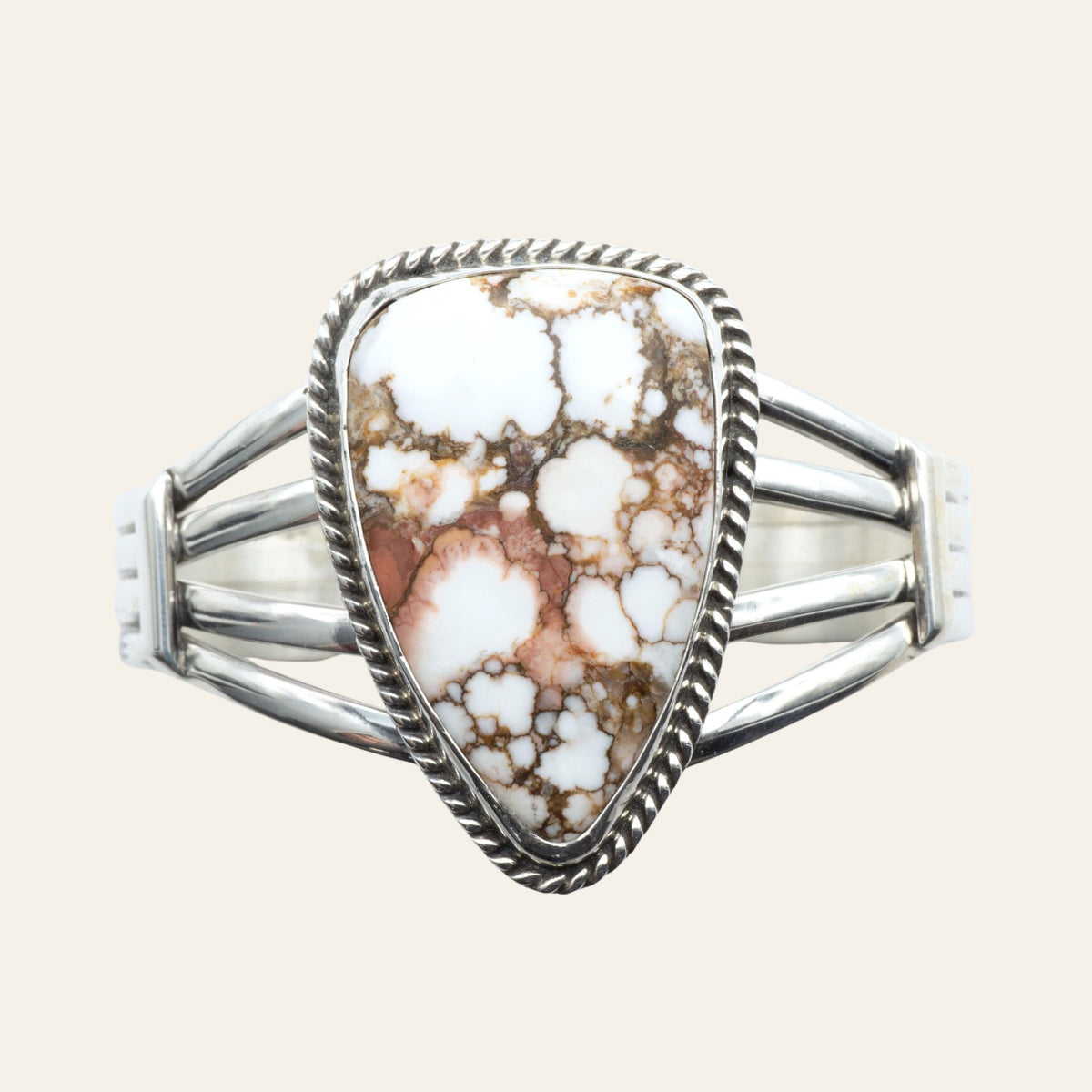 Wild Horse Rope Edge Cuff Bracelet in Navajo Sterling Silver, by P. Yazzie, shown on a cream background