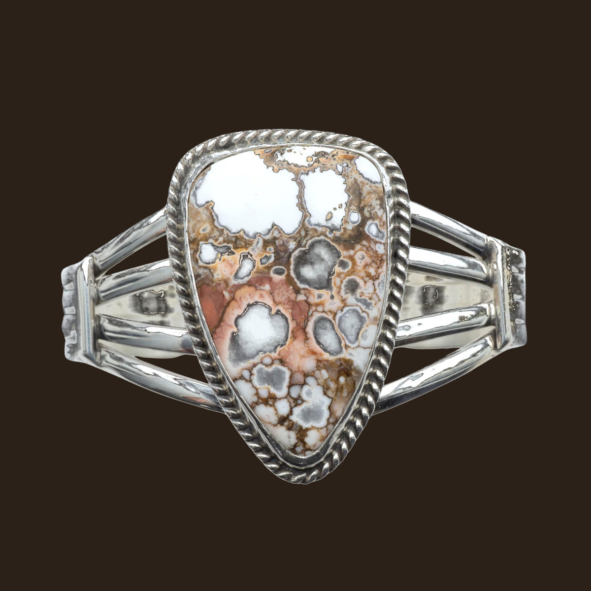 Wild Horse Rope Edge Cuff Bracelet in Navajo Sterling Silver, by P. Yazzie, shown on an espresso background