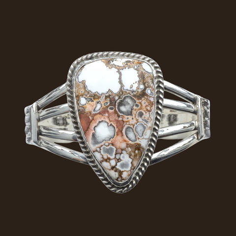 Wild Horse Rope Edge Cuff Bracelet in Navajo Sterling Silver, by P. Yazzie, shown on an espresso background