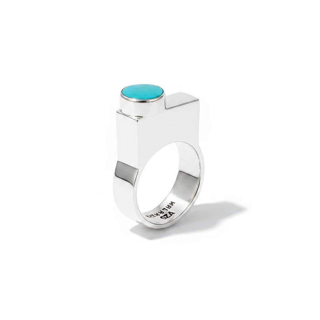 Wildflower Artisans BALAAM sterling silver ring featuring an off-center oval teal turquoise cabochon on a wide flat band