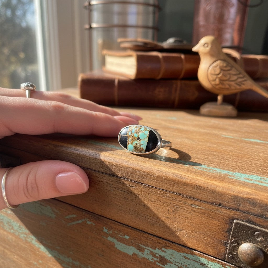 Wildflower Artisans Black Jack turquoise ring in sterling silver with bold black matrix on a wooden surface.