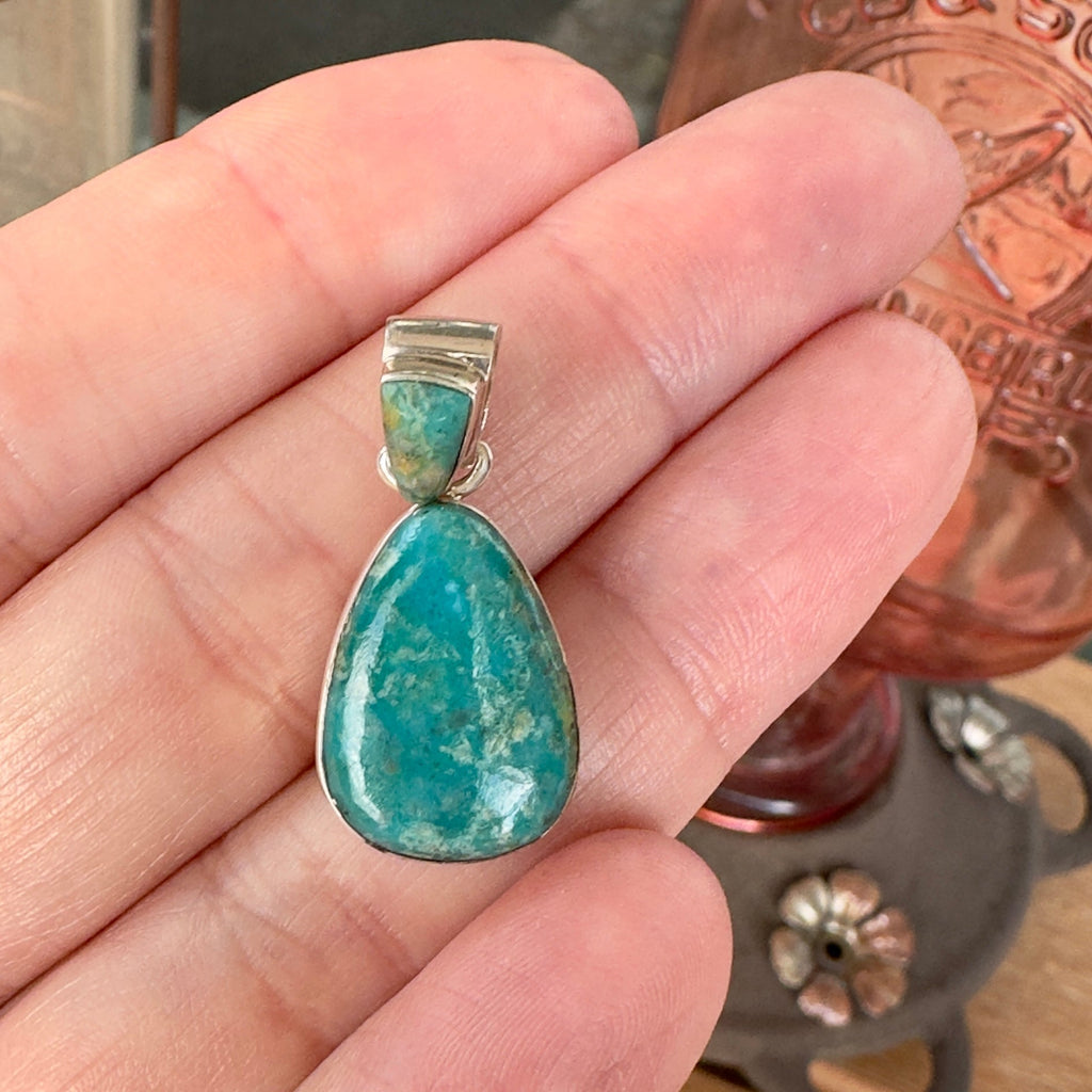 Wildflower Artisans Martinez Fox turquoise teardrop pendant in sterling silver held in a hand