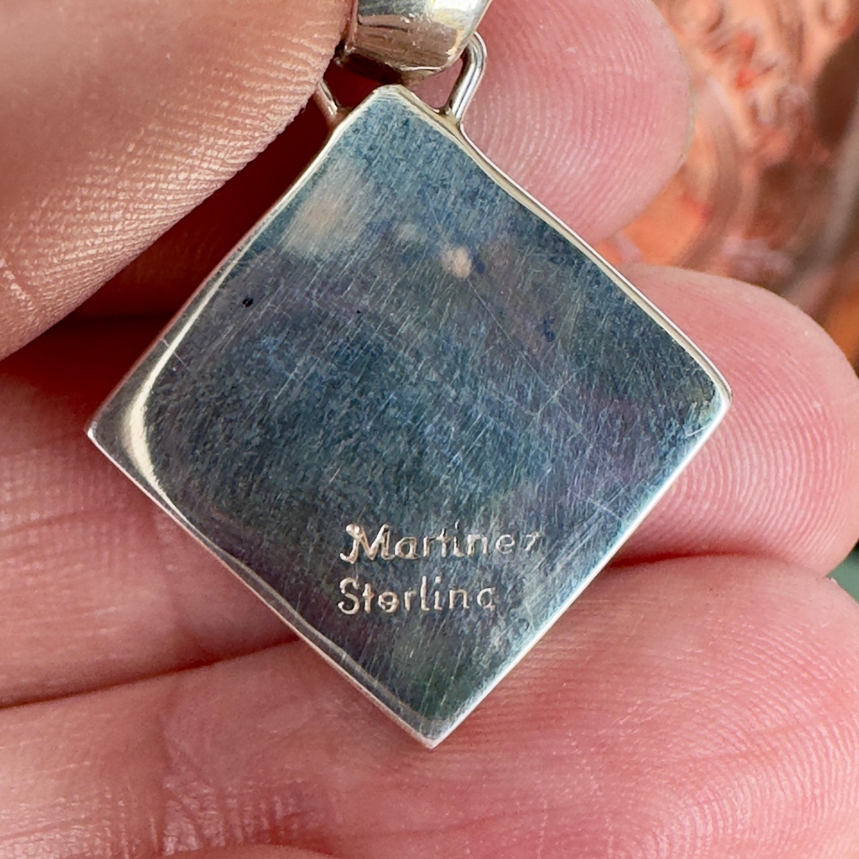 Wildflower Artisans sterling silver pendant back showing Martinez and sterling hallmark on a square setting