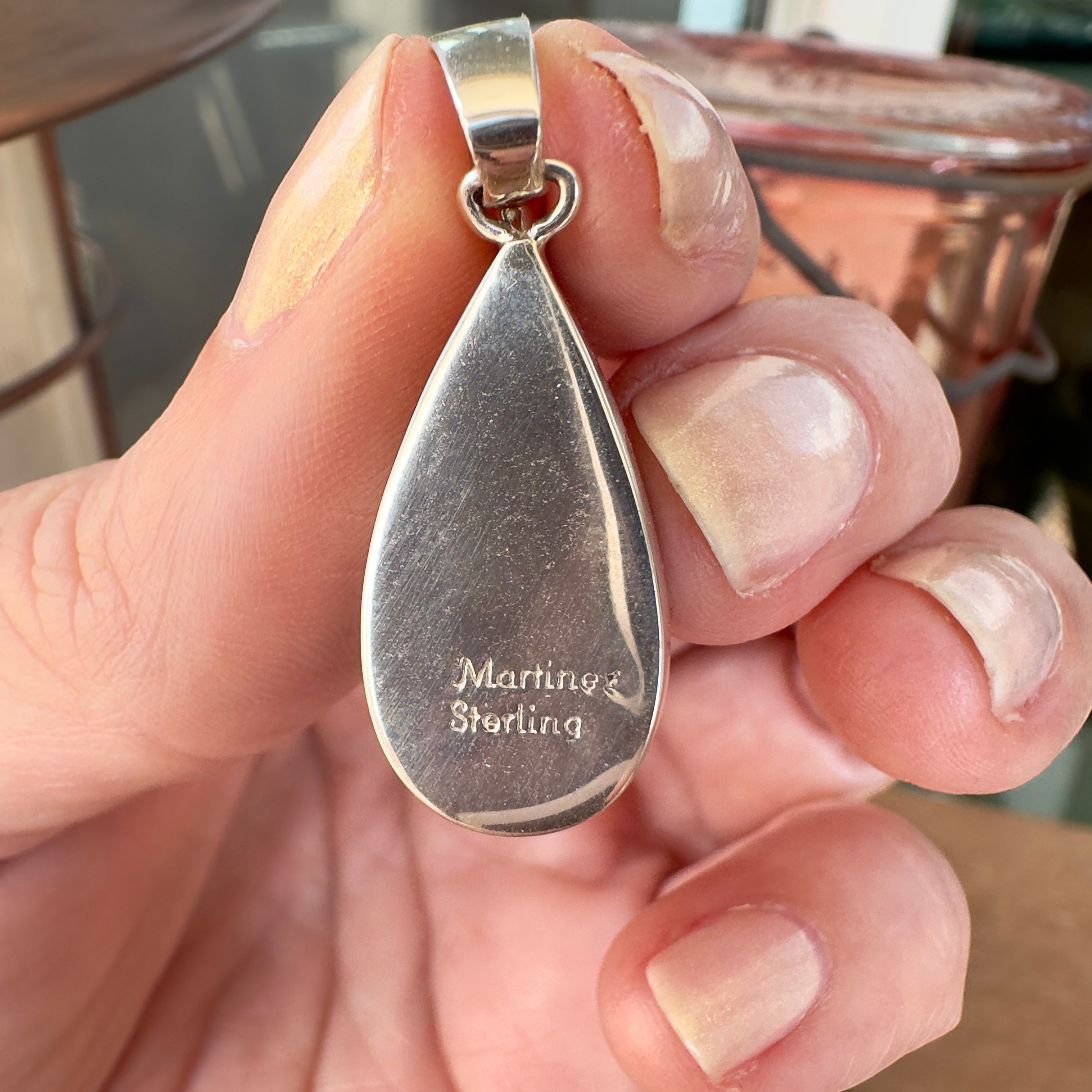 Back of Wildflower Artisans Martinez sterling silver teardrop pendant showing the hallmark engraving