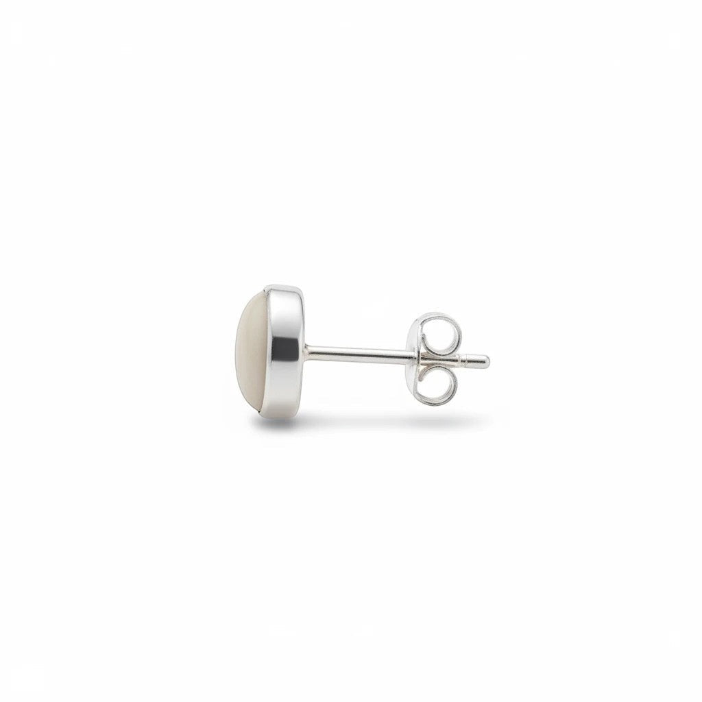 Wildflower Artisans round mother of pearl stud earrings in sterling silver, side view showing bezel setting.
