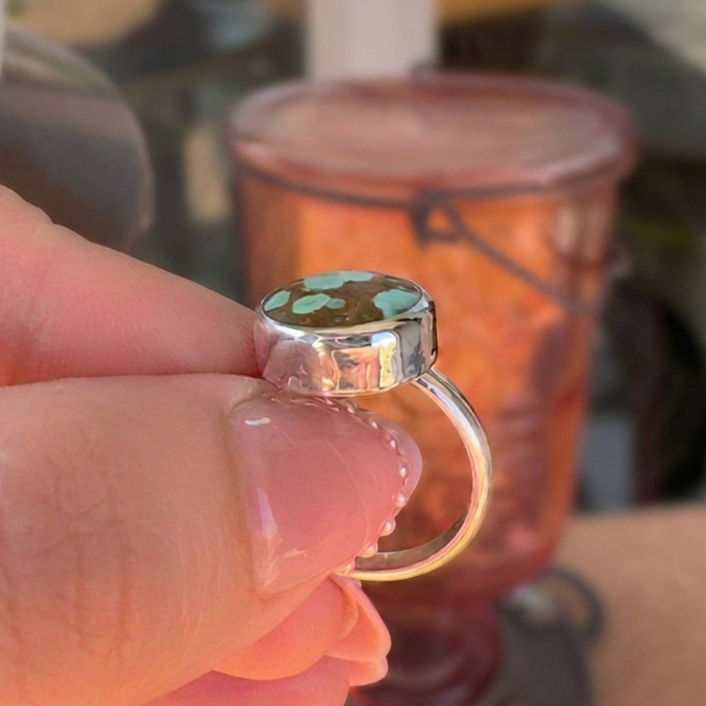 Wildflower Artisans sterling silver ring featuring a rare Number 8 turquoise stone with golden-brown spiderweb matrix.