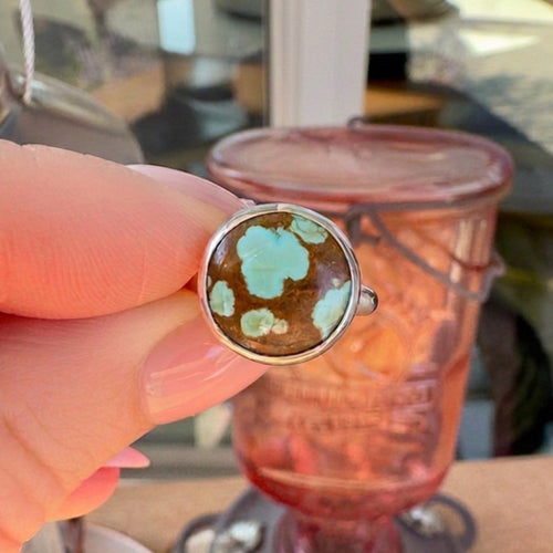 Wildflower Artisans sterling silver ring featuring a rare Number 8 turquoise stone with golden-brown spiderweb matrix.
