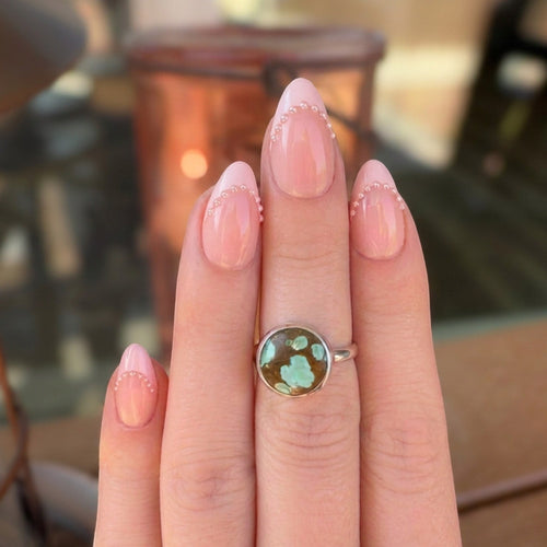 Wildflower Artisans sterling silver ring featuring a rare Number 8 turquoise stone with golden-brown spiderweb matrix.