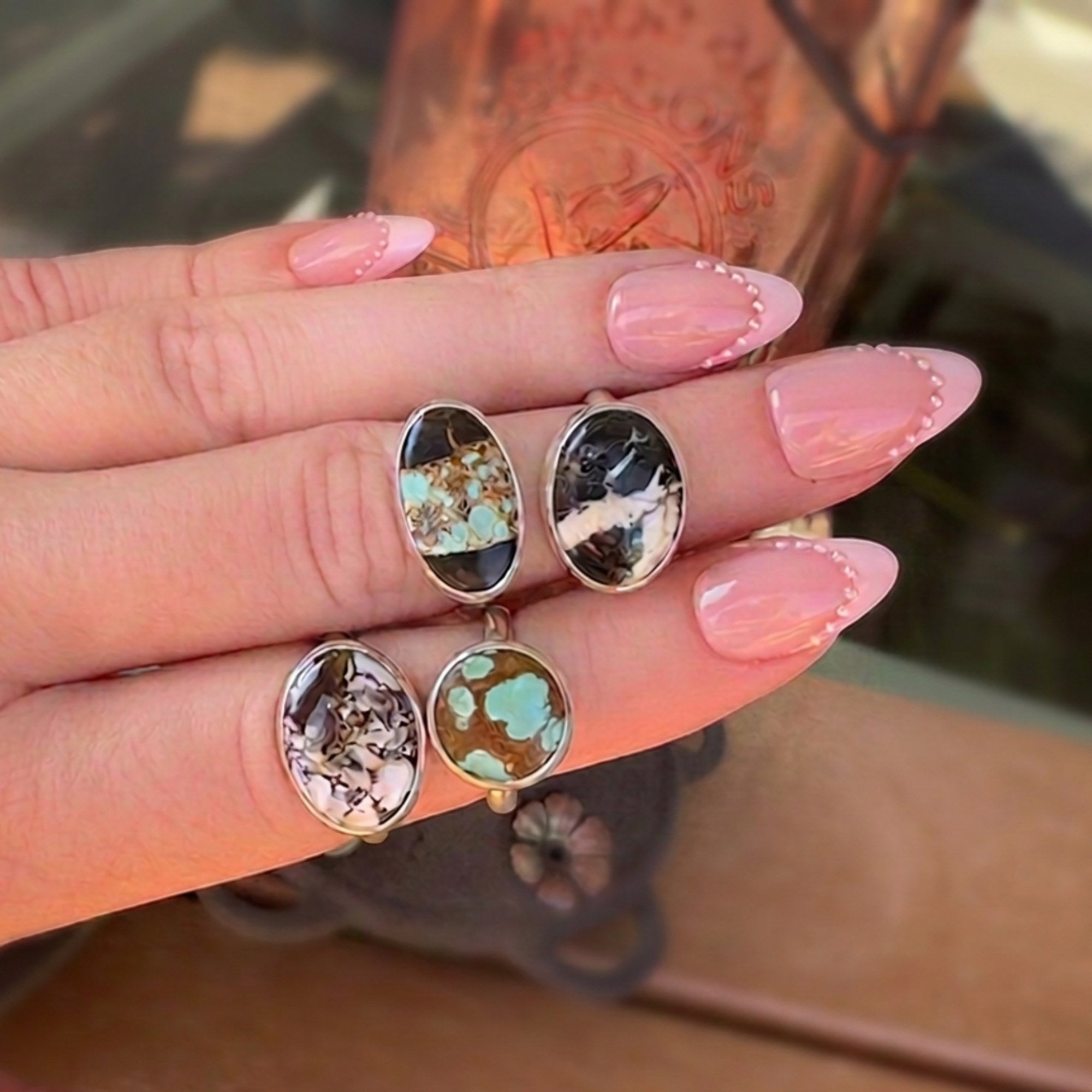 Wildflower Artisans sterling silver rings featuring oval Number 8 turquoise stones with unique spiderweb matrix patterns