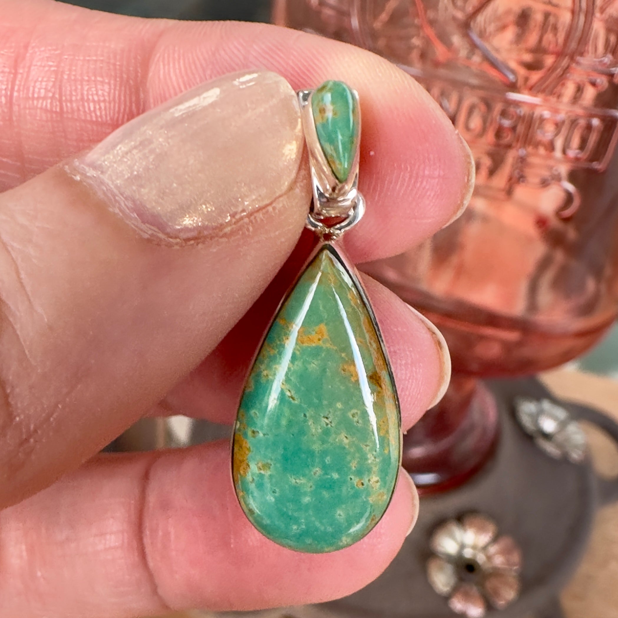 Wildflower Artisans Martinez Royston turquoise teardrop pendant in sterling silver with golden matrix held in hand